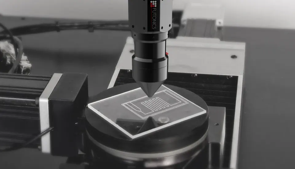 Microfluidic polymer structure being welded with a focused laser beam.