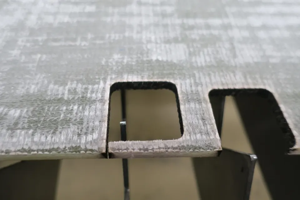 Laser-cut edge of a fiber-reinforced composite material.